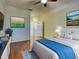 Bedroom featuring hardwood floors, ceiling fan, neutral walls, and comfortable furnishing at 912 Barclay Ct, Venice, FL 34293