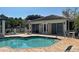A refreshing community pool offers relaxation and fun, with nearby seating and a shaded area at 912 Barclay Ct, Venice, FL 34293