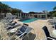 Community pool surrounded by lounge chairs and a pool house at 912 Barclay Ct, Venice, FL 34293