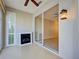 Sunroom with light-colored floors, fireplace, sliding glass doors and a ceiling fan at 912 Barclay Ct, Venice, FL 34293