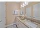 Well-lit bathroom with double sinks, granite countertops, and white cabinets at 9220 43Rd W Ter, Bradenton, FL 34209