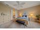 Comfortable bedroom with a tray ceiling, neutral walls, carpeted floor, and ensuite bath access at 9220 43Rd W Ter, Bradenton, FL 34209