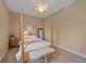 Bright bedroom with a four-poster bed, soft neutral tones, and fan at 9220 43Rd W Ter, Bradenton, FL 34209