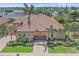 Elegant home showcasing a terracotta roof, well manicured landscaping, and a paver driveway at 9220 43Rd W Ter, Bradenton, FL 34209