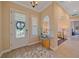Inviting home foyer with tile flooring, transom window, and an arched doorway leading to the living area at 9220 43Rd W Ter, Bradenton, FL 34209
