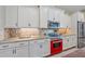 Kitchen featuring granite countertops, modern appliances, and white cabinets, with tiled backsplash at 9220 43Rd W Ter, Bradenton, FL 34209