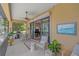 Covered lanai featuring a dining table and grill, with a view of the yard at 9220 43Rd W Ter, Bradenton, FL 34209