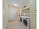 Bright laundry room features tile floor, front load washer and dryer, built in cabinetry, and folding area at 9220 43Rd W Ter, Bradenton, FL 34209