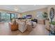 Bright living room featuring neutral walls, tile floors, and sliding glass doors to an outdoor patio at 9220 43Rd W Ter, Bradenton, FL 34209