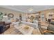 Open concept living room with neutral tones, tile floors, and a view to the kitchen and dining area at 9220 43Rd W Ter, Bradenton, FL 34209