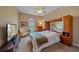 Relaxing bedroom featuring a built-in headboard, flatscreen tv, and soft lighting at 9220 43Rd W Ter, Bradenton, FL 34209