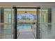 View through sliding glass doors to an enclosed lanai and swimming pool at 9220 43Rd W Ter, Bradenton, FL 34209