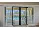 View through sliding glass doors to an enclosed lanai with a swimming pool at 9220 43Rd W Ter, Bradenton, FL 34209