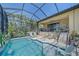 Inviting screened-in pool area with lounge chairs and lush landscaping at 9220 43Rd W Ter, Bradenton, FL 34209