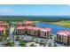 Beautiful aerial view of condos by the water, complete with parking and green landscaping at 97 Vivante Blvd # 306, Punta Gorda, FL 33950