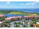 This aerial shot showcases the red-roofed buildings, surrounding landscaping and a serene lakefront setting at 97 Vivante Blvd # 306, Punta Gorda, FL 33950
