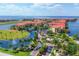 Stunning aerial view of a waterfront community with luxurious red-roofed condos and lush landscaping at 97 Vivante Blvd # 306, Punta Gorda, FL 33950