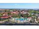 Aerial view showcasing a resort-style pool surrounded by palm trees and the beautiful waterfront community at 97 Vivante Blvd # 306, Punta Gorda, FL 33950