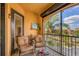 Outdoor balcony with seating offers beautiful views of the community and tropical landscaping at 97 Vivante Blvd # 306, Punta Gorda, FL 33950