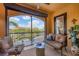 Outdoor balcony with comfortable seating and view of tropical landscaping and pond at 97 Vivante Blvd # 306, Punta Gorda, FL 33950