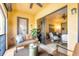 Balcony with view to living room, featuring comfortable seating with tropical landscape views at 97 Vivante Blvd # 306, Punta Gorda, FL 33950
