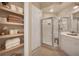 Well-lit bathroom with stand up shower and built-in shelving for towels and linens at 97 Vivante Blvd # 306, Punta Gorda, FL 33950
