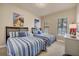 Comfortable bedroom with two twin beds, neutral decor, and carpeted floors at 97 Vivante Blvd # 306, Punta Gorda, FL 33950