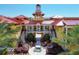 Grand courtyard entrance with a fountain, elegant columns, and beautifully manicured landscaping at 97 Vivante Blvd # 306, Punta Gorda, FL 33950