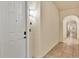 Hallway view showcases the neutral wall color, tile flooring and a white entry door at 97 Vivante Blvd # 306, Punta Gorda, FL 33950