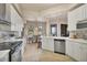 Well-lit kitchen with stainless steel appliances, white cabinets, and open to the dining area at 97 Vivante Blvd # 306, Punta Gorda, FL 33950