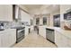 Bright kitchen featuring stainless steel appliances, white cabinets, and a stylish backsplash at 97 Vivante Blvd # 306, Punta Gorda, FL 33950