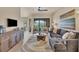 Comfortable living room with a ceiling fan, stylish rug, and plenty of natural light at 97 Vivante Blvd # 306, Punta Gorda, FL 33950