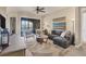 Comfortable living room with stylish furniture, a ceiling fan, and a view of the balcony at 97 Vivante Blvd # 306, Punta Gorda, FL 33950
