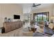 A bright, cozy living room featuring neutral tones, tile floors, elegant furniture, and a sliding glass door to the patio at 97 Vivante Blvd # 306, Punta Gorda, FL 33950