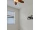Bright bedroom with ceiling fan, window with blinds, and tile flooring at 9823 Haze Dr, Venice, FL 34292