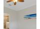 Neutral bedroom with tile floor, painting and bathroom access at 9823 Haze Dr, Venice, FL 34292