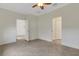 Bedroom featuring tile flooring, multiple doorways, and a ceiling fan at 9823 Haze Dr, Venice, FL 34292