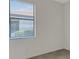 Bedroom with tiled floor and large window at 9823 Haze Dr, Venice, FL 34292