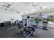 Well-equipped fitness center with modern exercise machines, TVs, and views of the pool area at 9823 Haze Dr, Venice, FL 34292