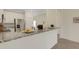 Modern kitchen with stainless steel appliances and a granite countertop bar area, perfect for entertaining at 9823 Haze Dr, Venice, FL 34292