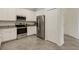 Well-equipped kitchen with stainless steel appliances and ample storage with white cabinets at 9823 Haze Dr, Venice, FL 34292