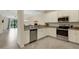 Modern kitchen design featuring stainless appliances, granite counters, open to living area at 9823 Haze Dr, Venice, FL 34292