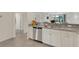 Modern kitchen with stainless appliances, sleek granite counters, with dishwasher at 9823 Haze Dr, Venice, FL 34292