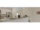Modern kitchen with stainless steel appliances and a granite countertop bar area, perfect for entertaining at 9823 Haze Dr, Venice, FL 34292