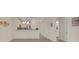 Living room with a view of the kitchen and another room, showcasing the open layout at 9823 Haze Dr, Venice, FL 34292