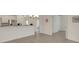 Bright living room with a view of the kitchen and other rooms, showcasing the open floor plan at 9823 Haze Dr, Venice, FL 34292