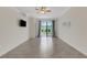 Open living room featuring tile floors, sliding glass doors to the patio, and a ceiling fan at 9823 Haze Dr, Venice, FL 34292