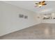 Bright open space with views to kitchen, tile floor and ceiling fan at 9823 Haze Dr, Venice, FL 34292