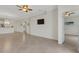 Spacious living room featuring tile floors, an open doorway, and a flat panel TV at 9823 Haze Dr, Venice, FL 34292
