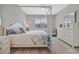 Bright bedroom with a four-poster bed, ceiling fan, and a view to the outside at 10121 Beachwalk Dr, Englewood, FL 34223